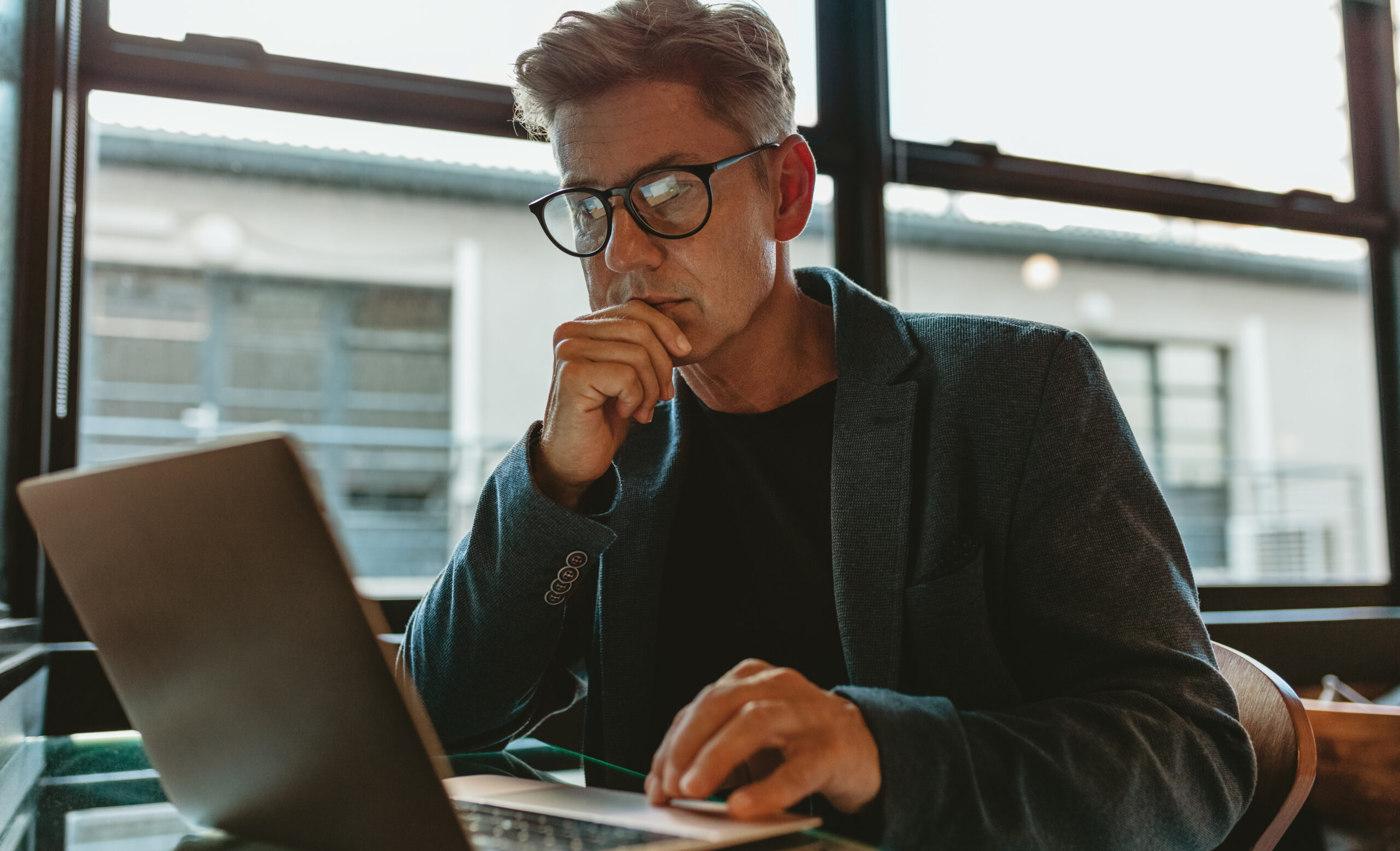 Man sitting at laptop working on a link building strategy. 