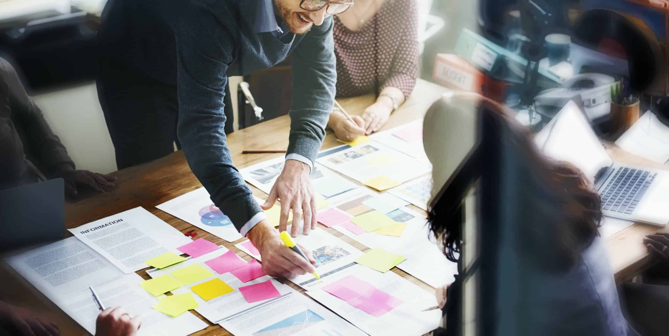 A group of people gathered around a table planning a law firm marketing strategy. 